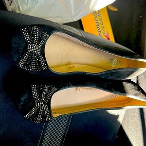 Black and gold slip ons